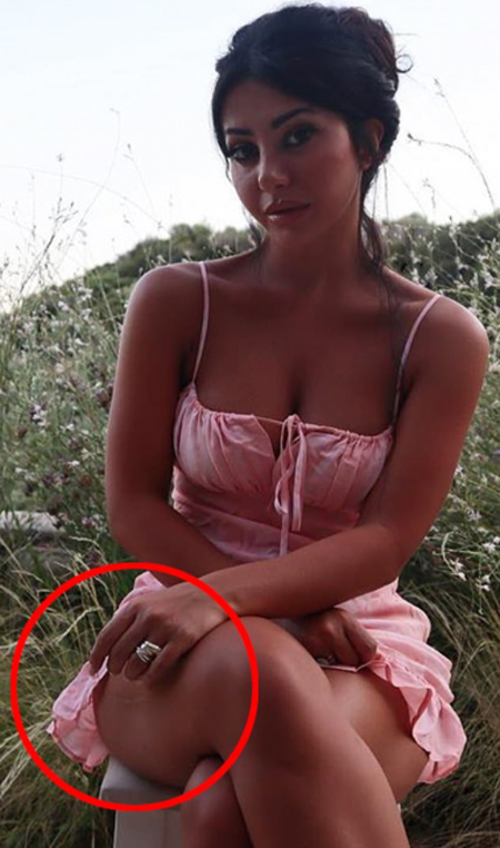 Martha Kalifatidis wearing a short pink one piece while sitting on a bench to take a picture outdoor.