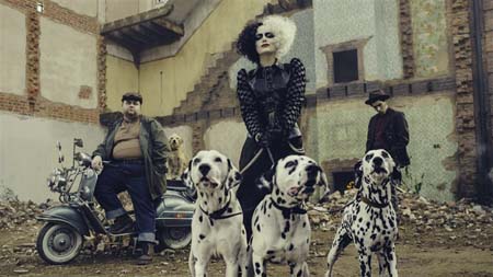 Cruella de Vil with three Dalmation dogs and her lackies in the background.