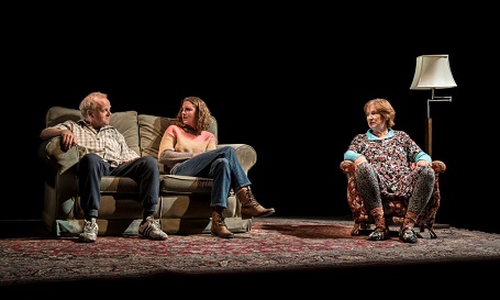 (From Left) Toby Jones, Louisa Harland (the two sitting on a two-person couch facing each other) and Deborah Findlay (on a separate single couch looking at the other two) in Imp at the Royal Court