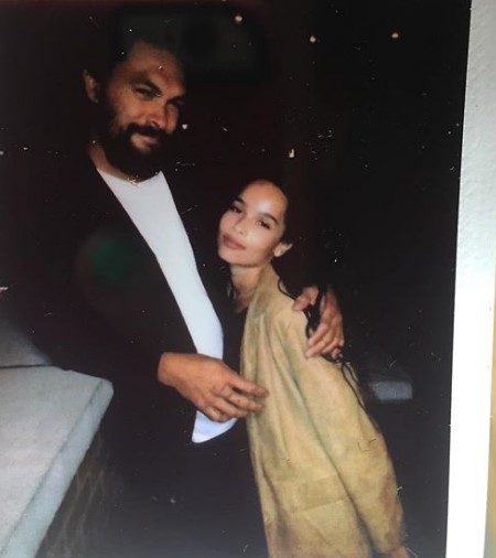 Jason Momoa with his daughter, Zoe Kravitz. The two seem to be in some kind of pub or event.