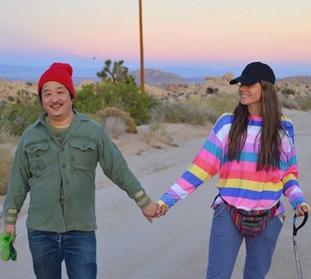 Bobby Lee and Khalyla Kuhn holding each other's hands.