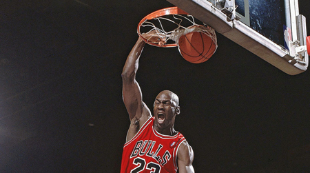 Michael Jordan dunking the ball.