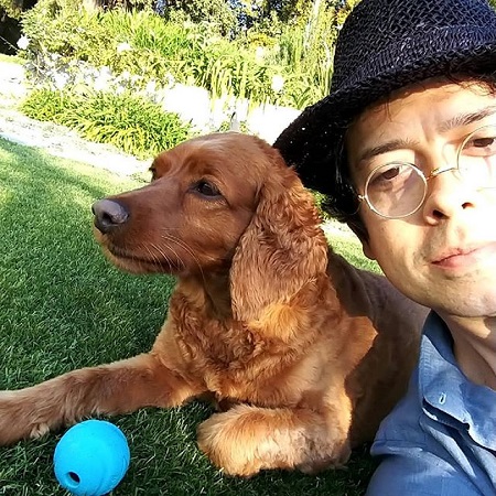 Geoffrey clicking a selfie with dog, ZouZou, as it is ignoring the camera.