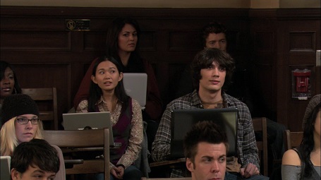 Hong Chau as 'Cook Pu' (middle left) on How I Met Your Mother, sitting in front of a laptop with her eyes rolled to the side.