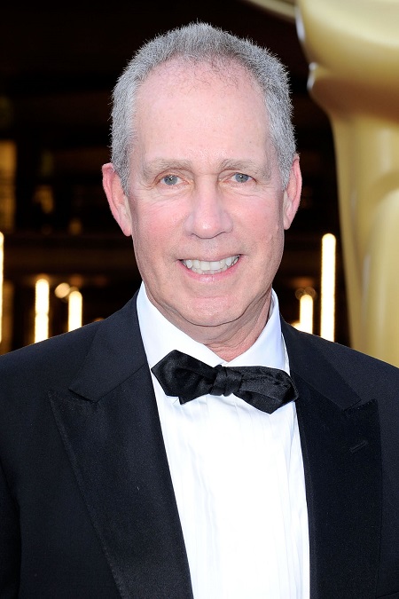 Michael Rosenberg smiling while wearing a suit with a bowtie.