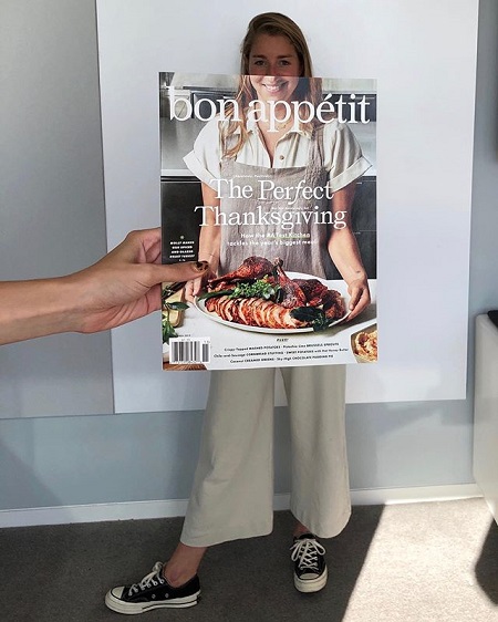 The body of Molly perfectly synchronized with her part seen photo on the cover of the Bon Appetit Magazine that is being held by someone else.