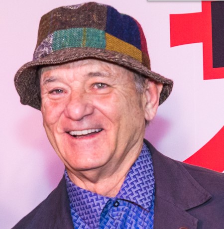 Bill Murray grinning for the camera while he wears a very weird hat.