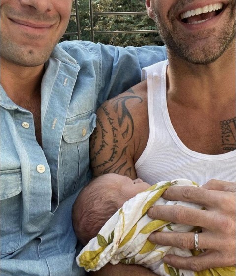 Ricky Martin with his husband Jwan, holding his fourth child, Renn.
