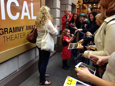 Laurel signing an autograph for a fan at the Grammy Awards.