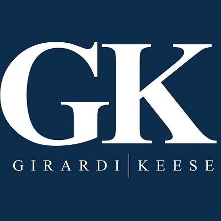 Logo of Girardi | Keese in a blue background.