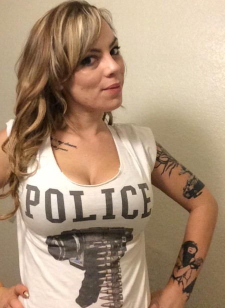 Fairbanks in a white t-shirt, showcasing her tattoos.