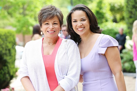 Laura (right) with her mother Valerie (right). Both smiling at the camera.