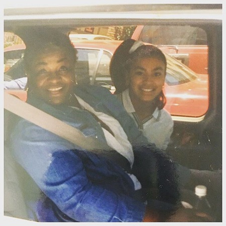 Early teen Liane with her grandmother in the back seat of a car,