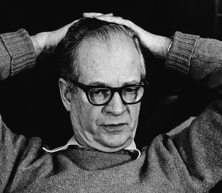 B.F. Skinner with his hands on his head.