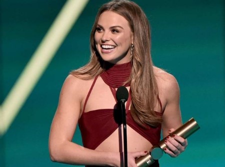 Hannah holding an award.