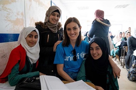 Samantha Vinograd with three Syrian refugees in the picture.