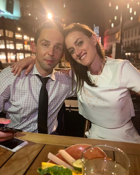 Samantha Vinograd with her right arm around Josh Campbell during a dinner with friends.