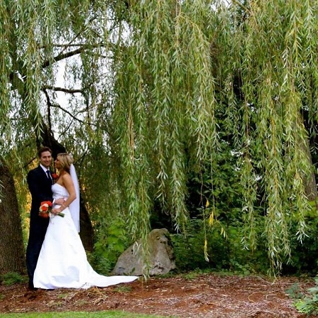 Liz and Adam in their wedding outfits during their wedding day.