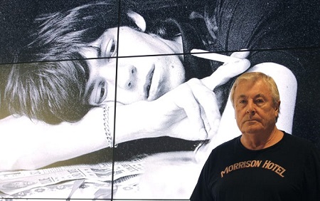 Terry O'Neill  poses in front of a picture of Mick Jagger during the exhibition 'Terry O'Neill: The Face of Legends' held at the Telefonica Foundation hall in Madrid on Oct. 10, 2013. O'Neill died Nov. 16, 2019, at the age of 81.