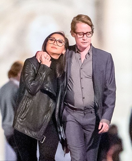 Macaulay's hand around Brenda's shoulder as they stroll Paris together in Thanksgiving 2017.