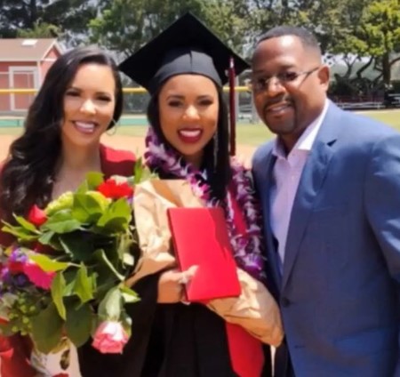 Iyanna Faith Lawrence with her parents at her graduation.