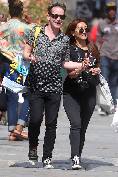 Macaulay and Brenda walking hand in hand smiling in Paris on December 2017.