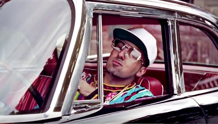 Puerto Rican rapper Termanology in a car looking out the window in a hip-hop outfit.