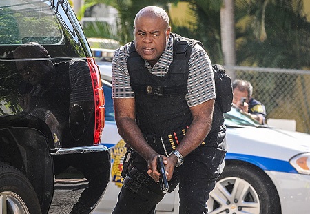 Chi McBride in 'Hawaii Five-0' during a sting operation  with bullet-proof vest and gun.