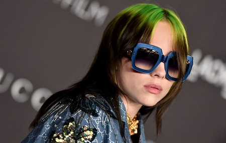 Billie Eilish is not looking for a boyfriend, but she is looking stunning in this photo wearing dorky blue-bordered spectacles.