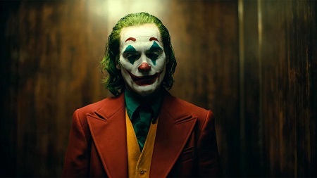Joaquin Phoenix in his Joker makeup looking glum.