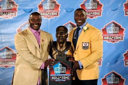 Former Denver Broncos TE Shannon Sharpe stands with his bust with brother Sterling Sharpe August 6, 2011 during the Pro Football Hall of Fame enshrinement in Canton, Ohio.