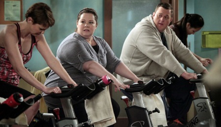 A scene from 'Mike & Molly' where the two characters are on treadmills.