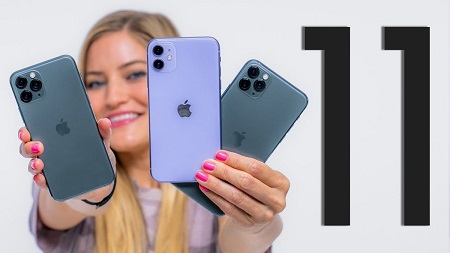 Justine Ezarik, known as iJustine, holding three multiple-camera iPhone 11s.