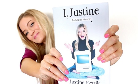 iJustine showcasing her memoir book, 'I, Justine: An Analog Memoir'.