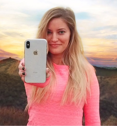 iJustine in one of her iPhone commercials holding the iPhone X in her right hand. Her net worth $3 million, but could be more.