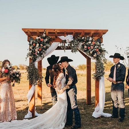 The wedding moment. Jess Lockwood and Hailey Kinsel kiss each other after saying their 'I do's and vows.