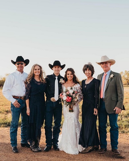 Jess Lockwood and Hailey Kinsel with their respective parents, all dressed appropriately for the occasion.