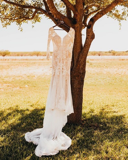 The bride's dress hanging from a tree as is the tradition.