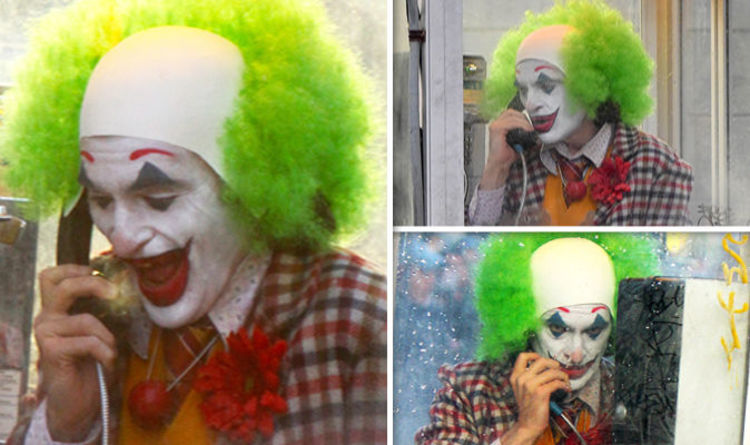 joaquin in clown get up inside the phone booth 