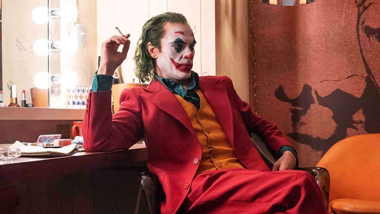 joker in red suit with cigarette in his hand