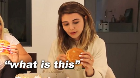 Olivia Jade holding a burger with the words 'what is this' written as caption on the photo.
