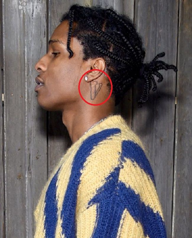 asap's left profile wearing yellow and blue stripped sweater showing the V tattoo 