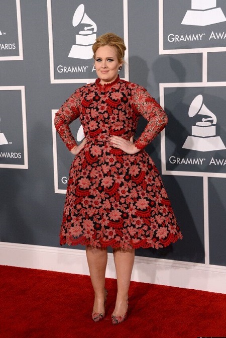 Adele in her floral gown at the 2013 Grammys with her arms in her waist like a princess.