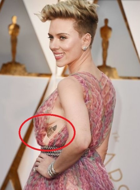 Scarlett Johansson has a rose tattoo under her left bosom.