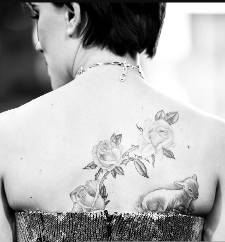 Floral design on the back with a lamb on the shoulder blade of Scarlett Johansson.