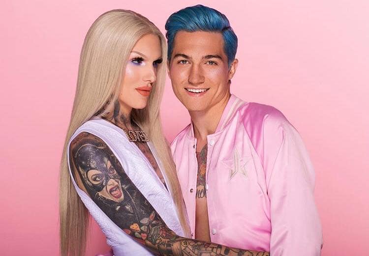 jeffree in white dress long blonde hair hugging boyfriend nathan whos wearing pink jacket with blue hair 