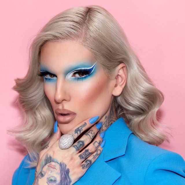 jeffree with blue eye shadow, blue nails blue blazer, blonde hair for a shoot 
