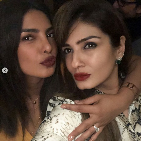 Priyanka Chopra pouting with a friend as she shows her engagement ring on her right hand.