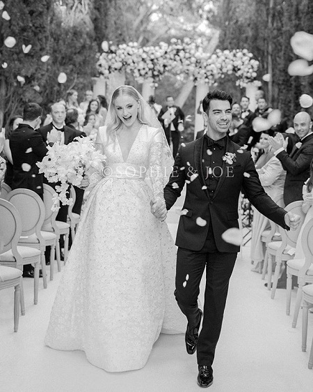 Sophie Turner and Joe Jonas during the wedding after being announced husband-wife and walking the aisle backwards.