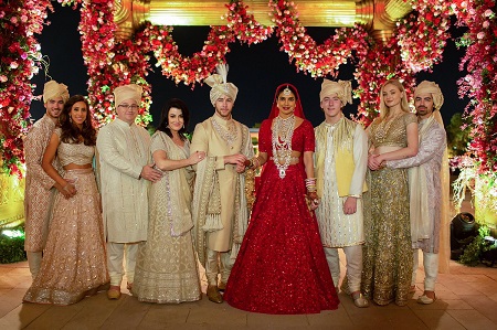 From left. Nick and Danielle, Paul Kevin Sr. and Denise, Nick and Priyanka, Frankie, Sophie and Joe, all posing in Indian wedding-occasion dresses.